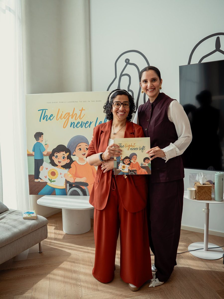 Rucha Daryani and Sania Mirza holding The Light Never Left at the launch in Dubai
