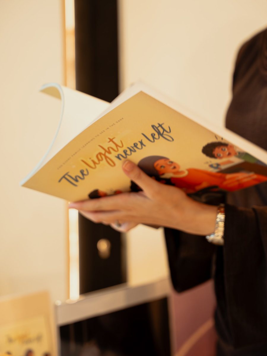 A reader holding The Light Never Left open